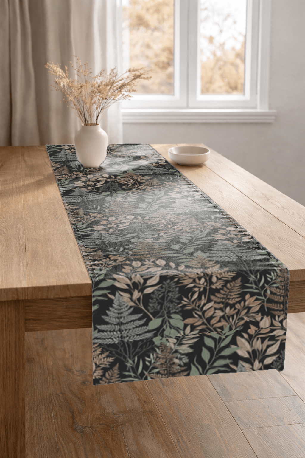 botanical fern table runner draped over a modern wooden dining table in a bright minimalist dining room