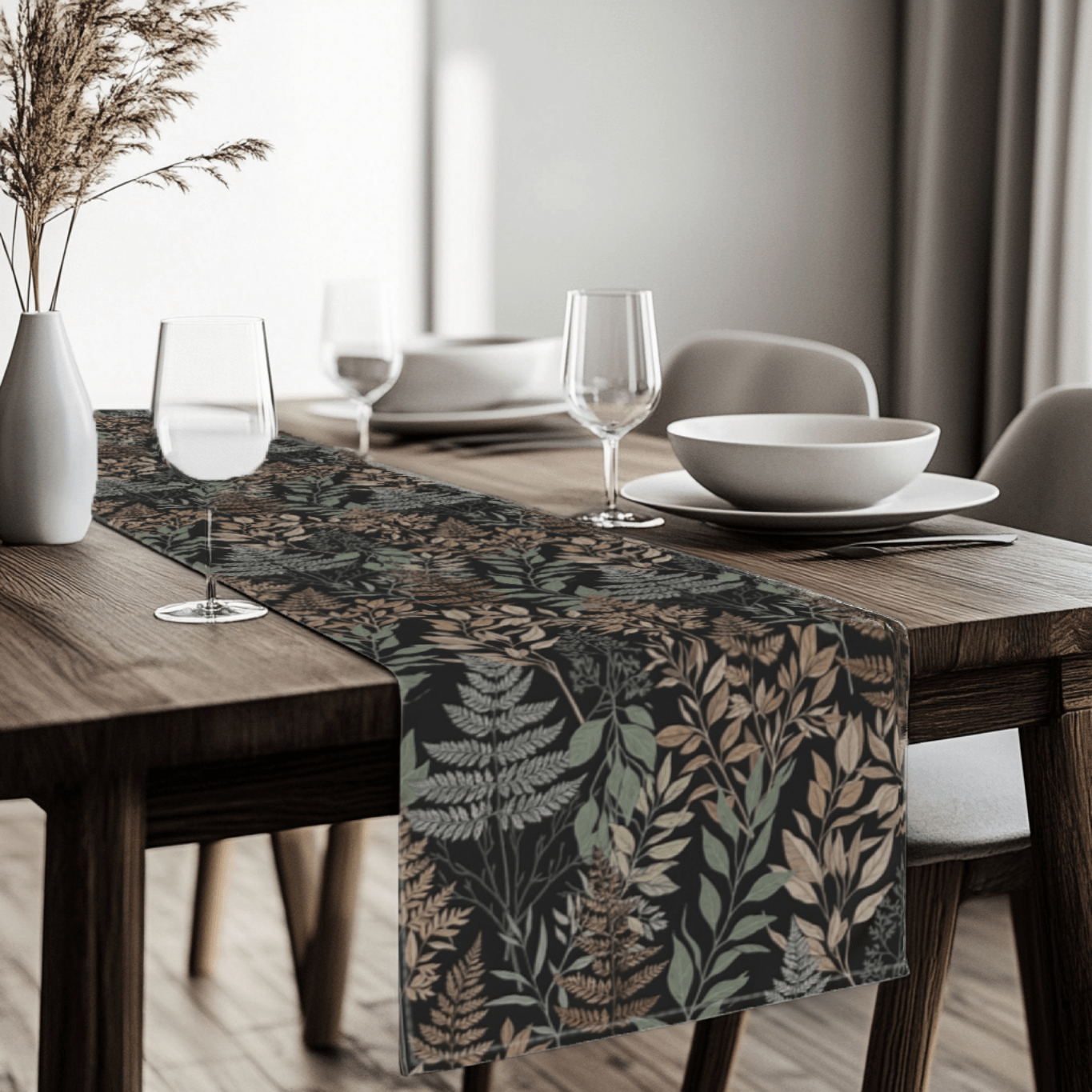 Nature inspired botanical table runner styled across a modern dining table with neutral table setting.