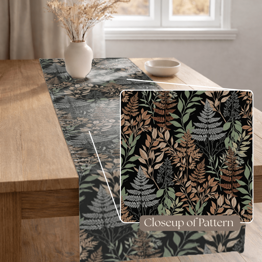 Botanical foliage table runner showing detailed fern and leaf pattern on dark background.